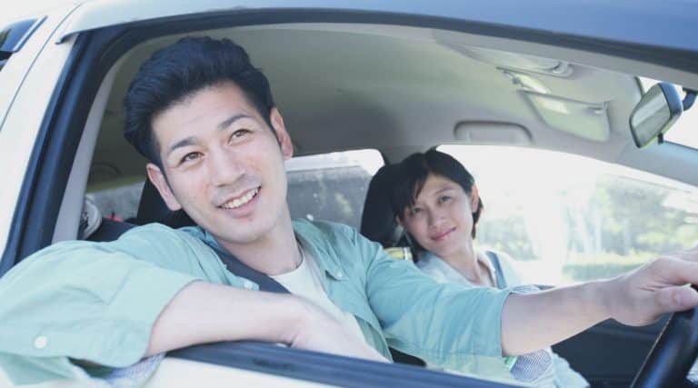 Couple looking out the window of their car